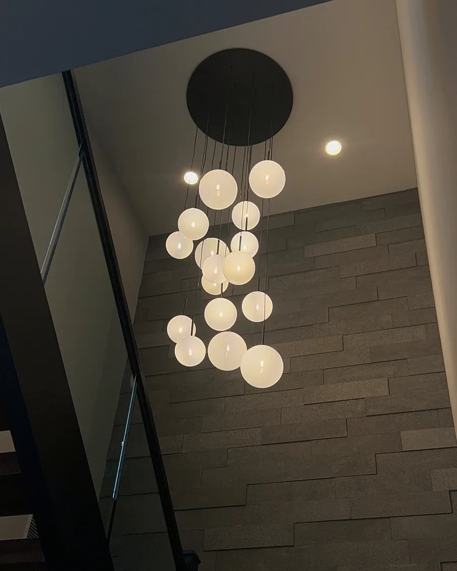 Globe pendant cluster in a two-story stairwell